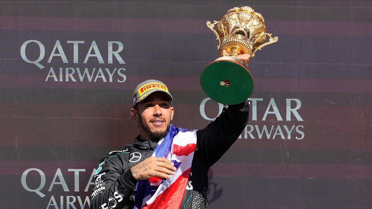 (AP Photo/Luca Bruno) : Mercedes driver Lewis Hamilton of Britain celebrates on the podium after winning the British Formula One Grand Prix race at the Silverstone racetrack, Silverstone, England, Sunday, July 7, 2024. 